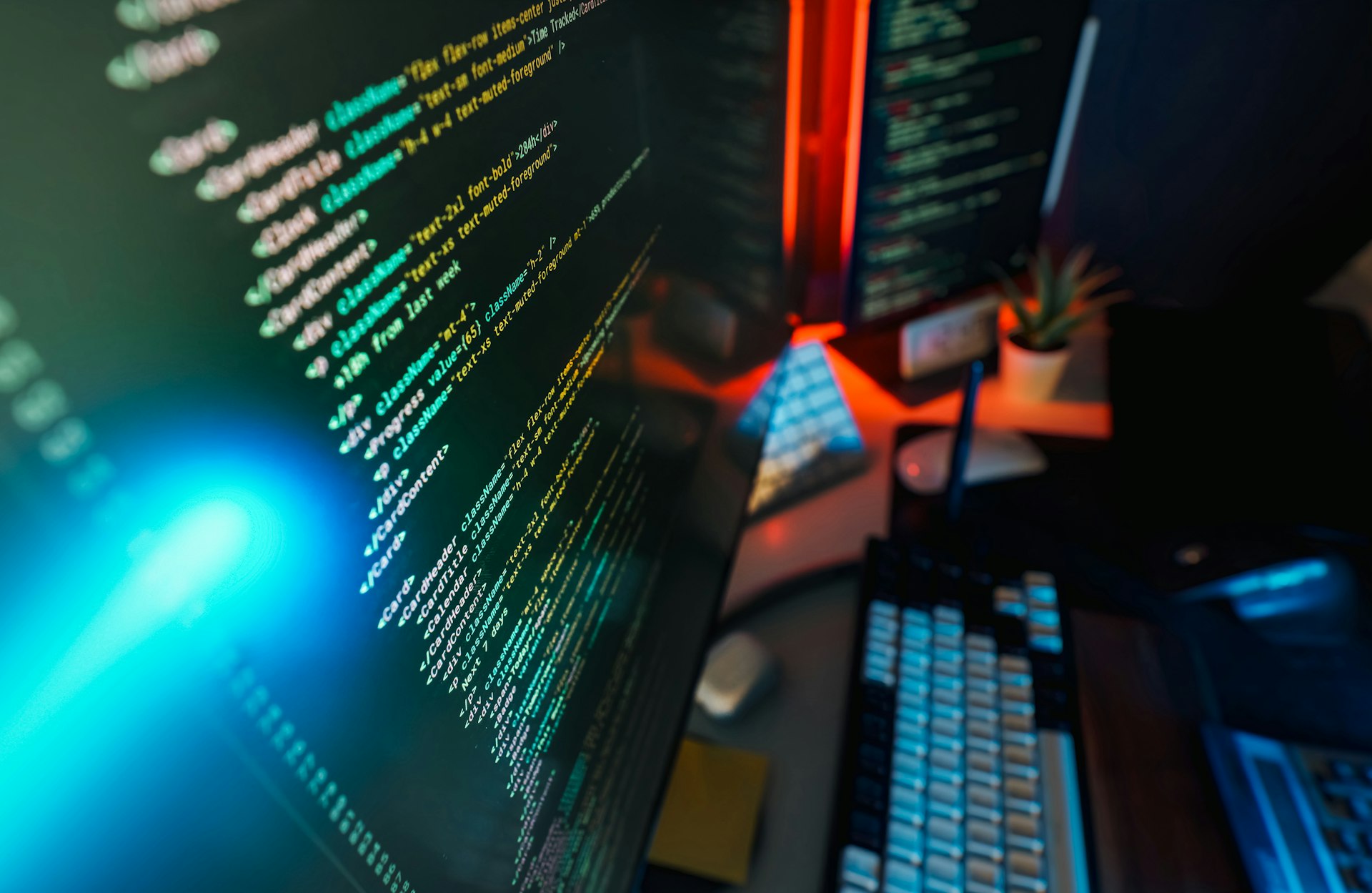 Close-up of website code on a screen with neon lighting